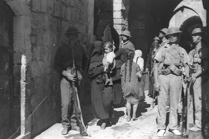 ARMED BRITISH SOLDIERS PATROLLING A NARROW STREET IN THE OLD CITY OF JERUSALEM DURING THE ARAB RIOTING AGAINST JEWS UNDER THE BRITISH MANDATE. חיילים D221 011