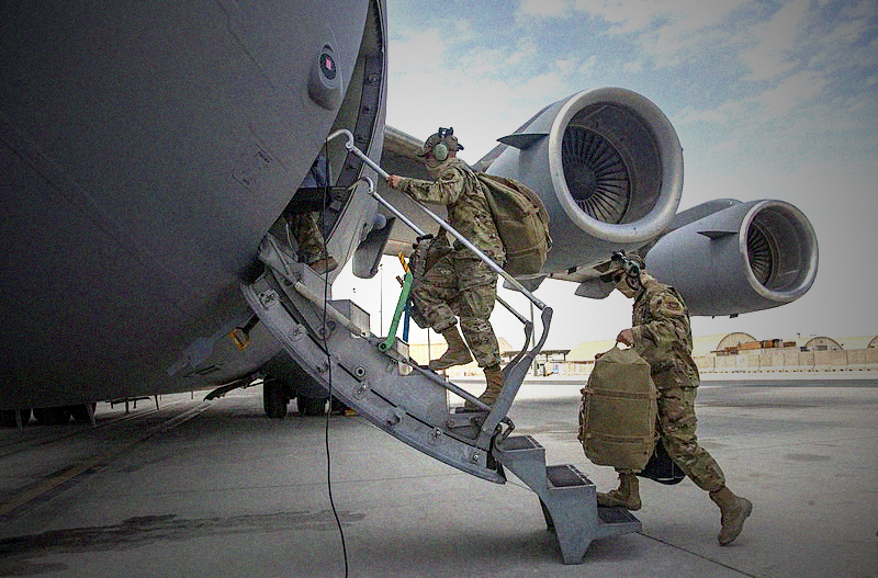 Aircrew assigned to Al Udeid Air Base, Qatar, carry their gear into a C-17 Globemaster III assigned to Joint Base Charleston, South Carolina, April 27, 2021, at Al Udeid AB. U.S. Air Force C-17s and other mobility aircraft around the U.S. Air Forces Central theater are assisting with the safe and orderly drawdown operations from Afghanistan. (U.S. Air Force photo by Staff Sgt. Kylee Gardner)